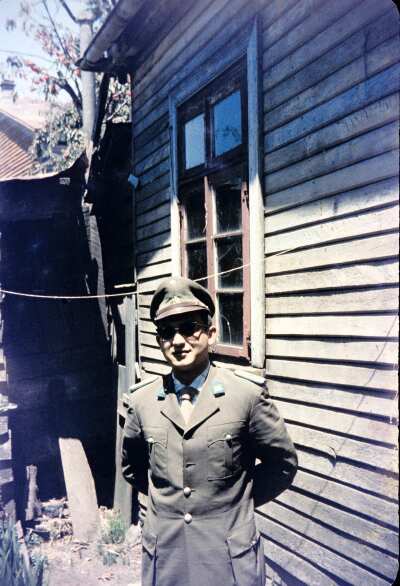Retrato de plano medio de Hombre con uniforme de carabinero posando de frente en el patio de una casa