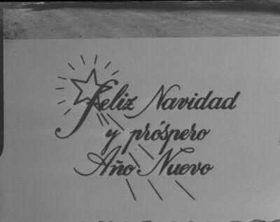 Reproducción de fotografía. Primer plano de postal -Feliz Navidad y próspero año nuevo-